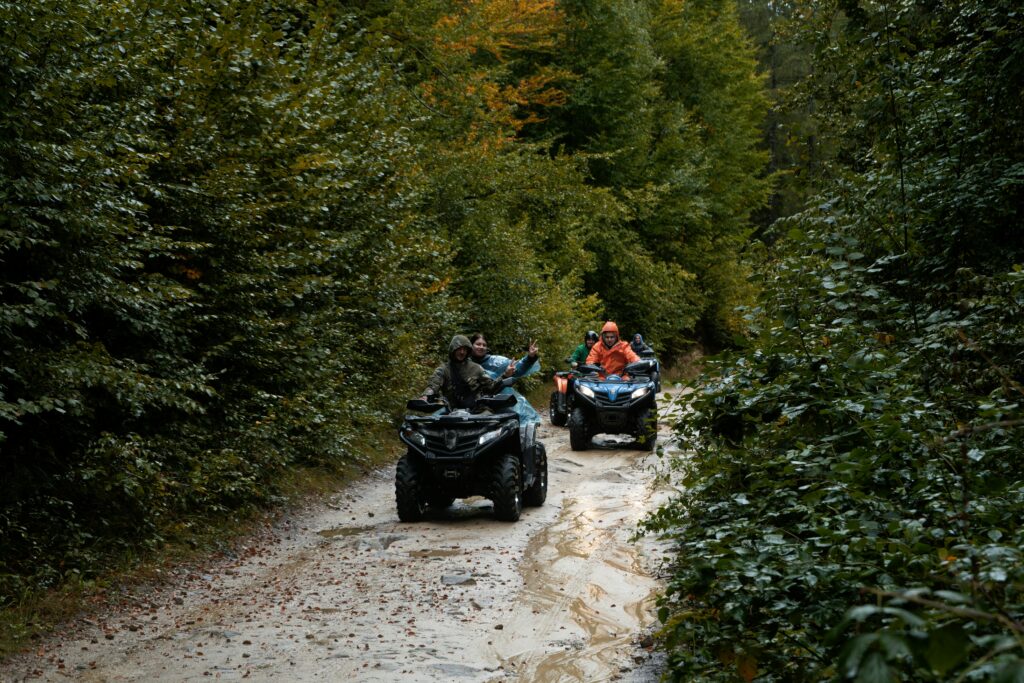Group enjoying an adventurous ATV ride through a lush forest trail, exploring nature.